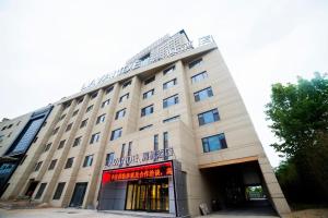 a large white building with a sign on it at Lavande Hotel Taian Dongyue Street Daimiao in Tai'an