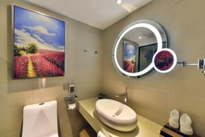a bathroom with a white toilet and a mirror at Lavande Hotel Xining Haihu New District Wanda Plaza in Xining +21 photos