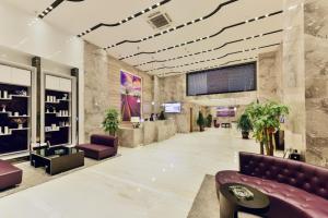 a lobby with a couch and chairs in a building at Lavande Hotel Xining Haihu New District Wanda Plaza in Xining