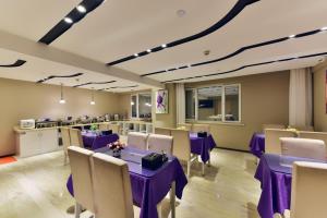 a dining room with purple tables and chairs at Lavande Hotel Xining Haihu New District Wanda Plaza in Xining