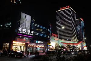 a city street at night with tall buildings at Lavande Hotel Dongguan Humen Wanda Square in Dongguan