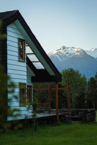 
a house with a view of a mountain range at Yelcho en la Patagonia in Chaitén
