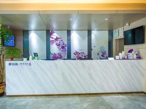 a large white counter in a room with purple flowers at Lavande Hotel Yanan Pagoda Mountain in Yan'an