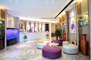 a lobby with purple and white chairs and tables at Lavande Hotel Lanzhou Chengguan Bridge in Lanzhou