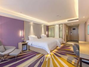 a large bedroom with a large bed and a chair at Lavande Hotel Chongqing Jiangbei International Airport Center in Yubei