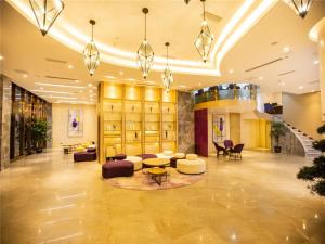 a lobby with couches and tables in a building at Lavande Hotel Mianyang Jiangyou Monument in Jiangyou