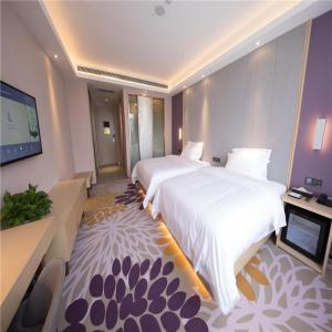a hotel room with a large bed and a flat screen tv at Lavande Hotel Ordos Ejinholo street in Ordos +29 photos
