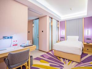 een slaapkamer met een bed, een bureau en een stoel bij Lavande Hotel Zhaoqing Qixingyan Scenic Spot Yihua International Square in Zhaoqing