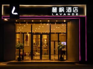 a store front at night with lights in the window at Lavande Hotel Yibin University City Exhibition Center in Yibin