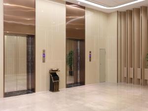 a hallway with columns in a building at Lavande Hotel Dongguan Liaobu Center in Dongguan