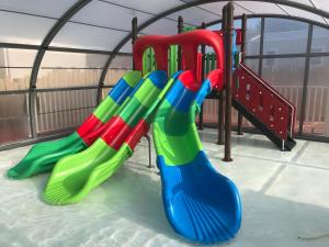 a group of colorful slides on a playground at Camping le Rivage in Quettehou