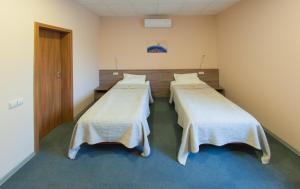 a hospital room with three beds in it at Air Kaunas in Karmėlava