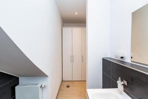 a bathroom with a white sink and a staircase at Hotel Havana in Mainz +73 photos