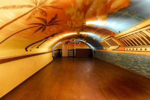 a bowling alley with a mural of palm trees on the wall at Hotel Havana in Mainz