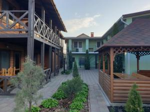 a courtyard with a gazebo next to a building at Хутірська 48 in Sanzhiyka