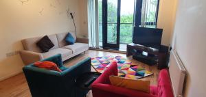 a living room with two couches and a tv at Garland Modern Apartment, Greenhithe 1 With Parking in Dartford