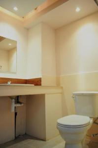 a bathroom with a toilet and a sink at Yoont Hotel in Ban Khun Yuam