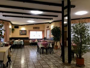 a restaurant with tables and chairs in a room at Guest House Atelšek in Rečica ob Savinji