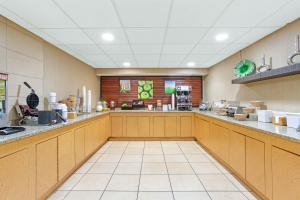 a large kitchen with wooden cabinets and counters at Quality Inn Slidell I-10 in Slidell