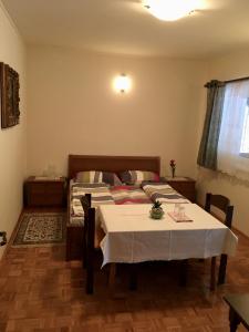 a bedroom with a bed and a table with a white table cloth at Guest House Atelšek in Rečica ob Savinji