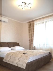 a bedroom with a large bed and a window at Apartment Sweethome 2 FREE PARKING in Uzhhorod