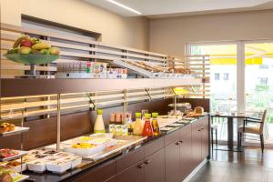 a kitchen with a bunch of food on display at NH Berlin Potsdamer Platz in Berlin