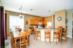 a kitchen and dining room with a table and chairs at Pool Home in Golf Community Next to Disney World in Davenport