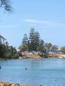 a group of people in the water on a lake at Marcel Towers Holiday Apartments in Nambucca Heads