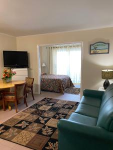 a living room with a couch and a bedroom at Boardwalk Terrace Apartments in Ocean City
