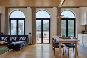a kitchen and living room with a table and a couch at Little Tai Hang in Hong Kong
