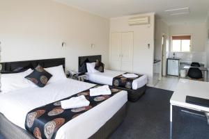 a hotel room with two beds and a kitchen at Best Western Mill Park Motor Inn in Morang