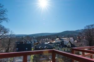 a view of a town with the sun in the sky at Apartamenty Izerskie - ul. Sienkiewicza 9 in Świeradów-Zdrój