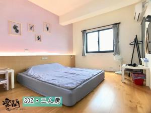 Llit o llits en una habitació de Le Nao Tourist Hostel