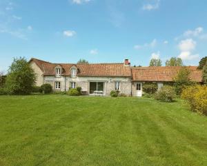 a large house with a large yard in front of it at La ferme aux grenouilles in Saint-Josse