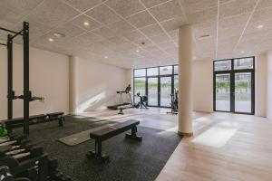 a fitness room with a gym with tread machines at CIM Aparthotel in Sant Cugat del Vallès