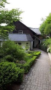 a house with a brick driveway next to a house at Sissi's Feriendomizil in Winterberg