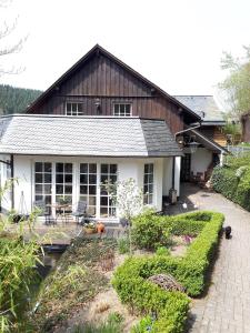 a small house with a patio in front of it at Sissi's Feriendomizil in Winterberg