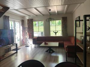 a living room with a couch and a table at De Specht in Bergen