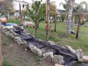 a rock retaining wall in a park with a creek at agriturismo heaven in Capo Vaticano