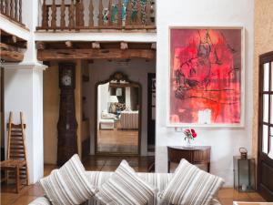a living room with a couch and a painting on the wall at Cas Gasi in Santa Gertrudis de Fruitera
