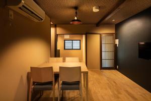 a dining room with a table and chairs at Kanade Inari-Sandomae in Kyoto
