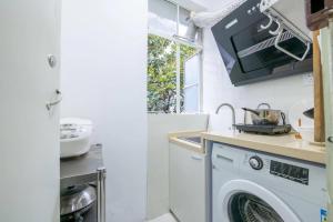 a kitchen with a washing machine and a sink at Jingyi Apartment in Shanghai