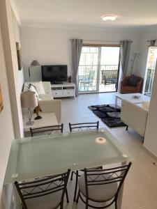 a living room with a table and chairs at Holiday Apartment Near The Sea in Galé