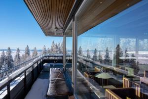 a building with a view of the snow covered mountains at Voksenasen Hotell; Best Western Signature Collection in Oslo