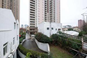 a street in a city with tall buildings at Jingyi Apartment in Shanghai