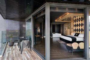a bedroom with a bed and a table and chairs at H Hotel & SPA - Adults Only in St. Julianʼs