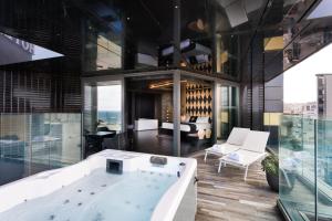 a bath tub in the middle of a room at H Hotel & SPA - Adults Only in St. Julianʼs