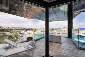 a view from the top of a building with glass windows at H Hotel & SPA - Adults Only in St. Julianʼs