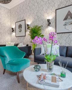 a living room with a couch and a table at Mentone Hotel in London