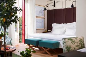 
a bedroom with a large bed and a large window at Hotel Cort in Palma de Mallorca
